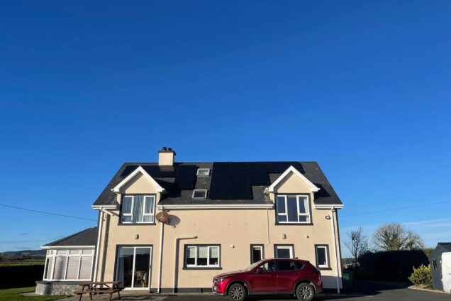 sun shining on home with solar panels